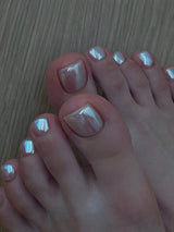 Close-up of feet with polished toenails on a wooden floor.
