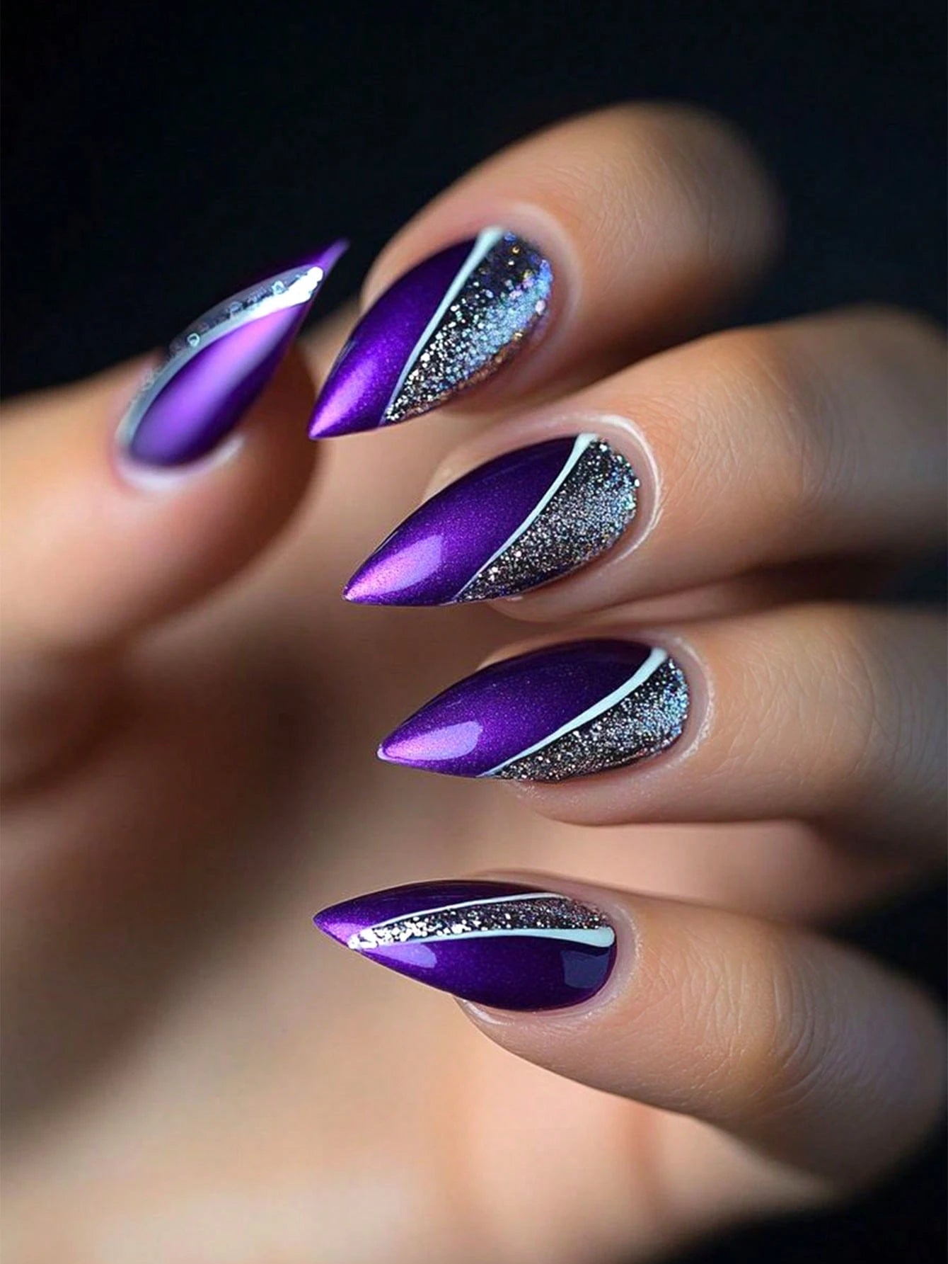 Purple and silver stiletto nails on a blurred background