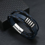 Blue braided leather bracelet with silver accents on a dark textured surface