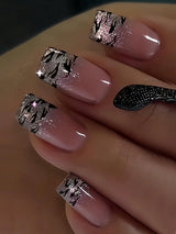 Nails with pink polish and silver decorative patterns on a neutral background