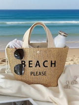 Beach bag with 'BEACH PLEASE' text on a sandy beach with ocean view