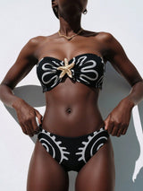 Black and white patterned bikini with starfish design on a plain background