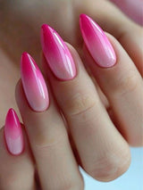 Hand with pink and red gradient nail polish on a light background