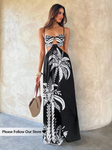 Woman wearing a black and white patterned dress against a neutral background