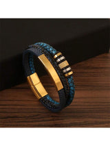 Multistrand leather bracelet with gold and silver accents on a wooden surface