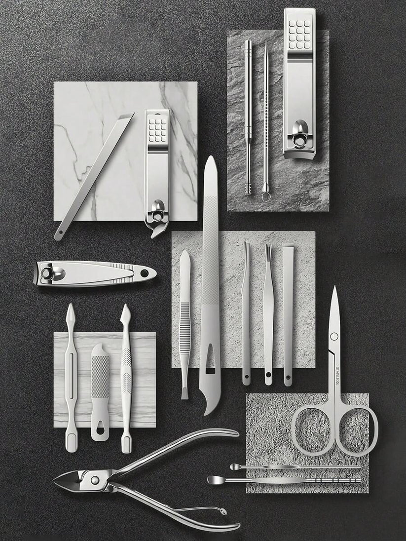 Collection of nail care tools on a dark surface with marble accents