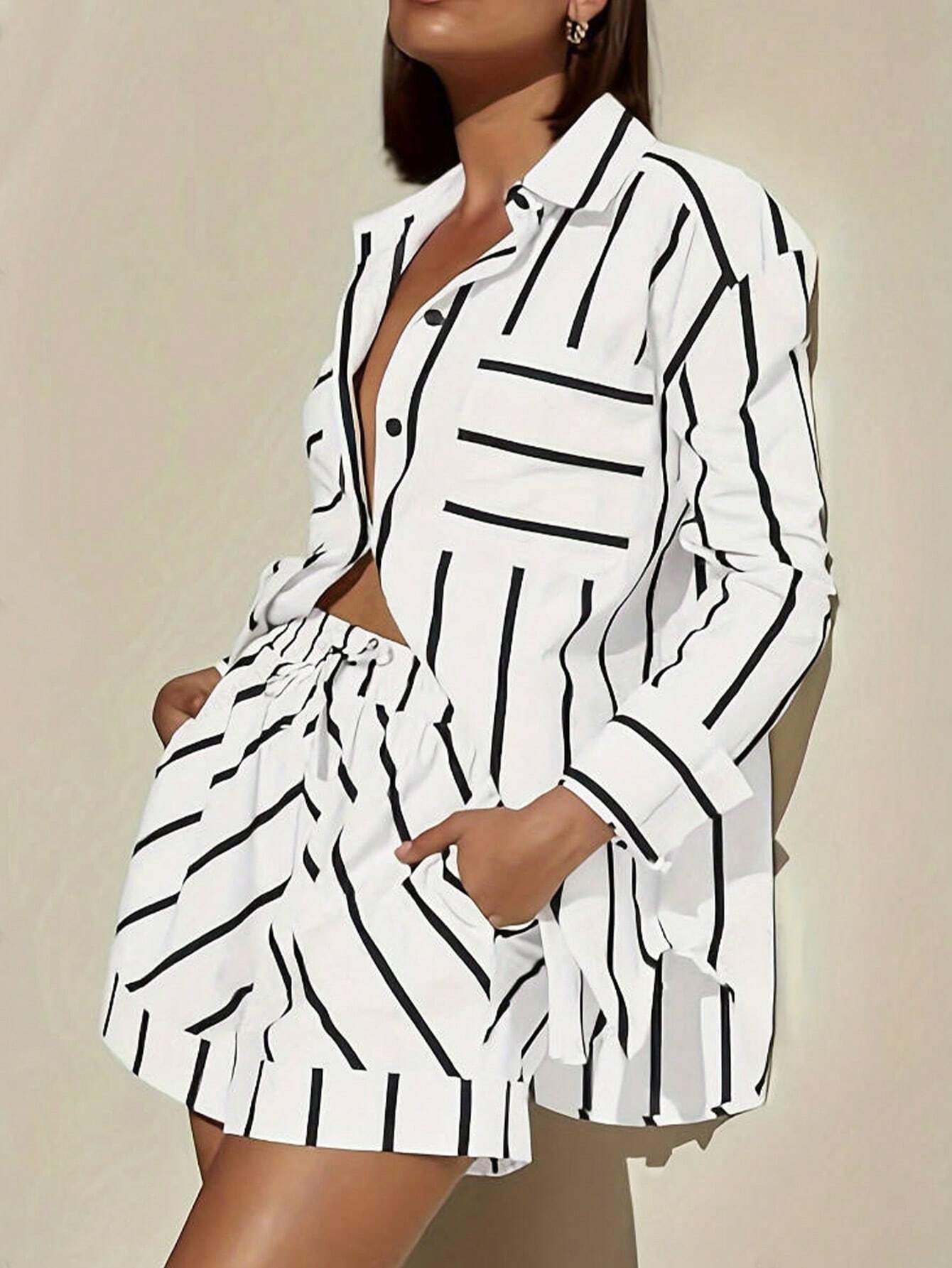 Person wearing a white outfit with black vertical stripes on a beige background