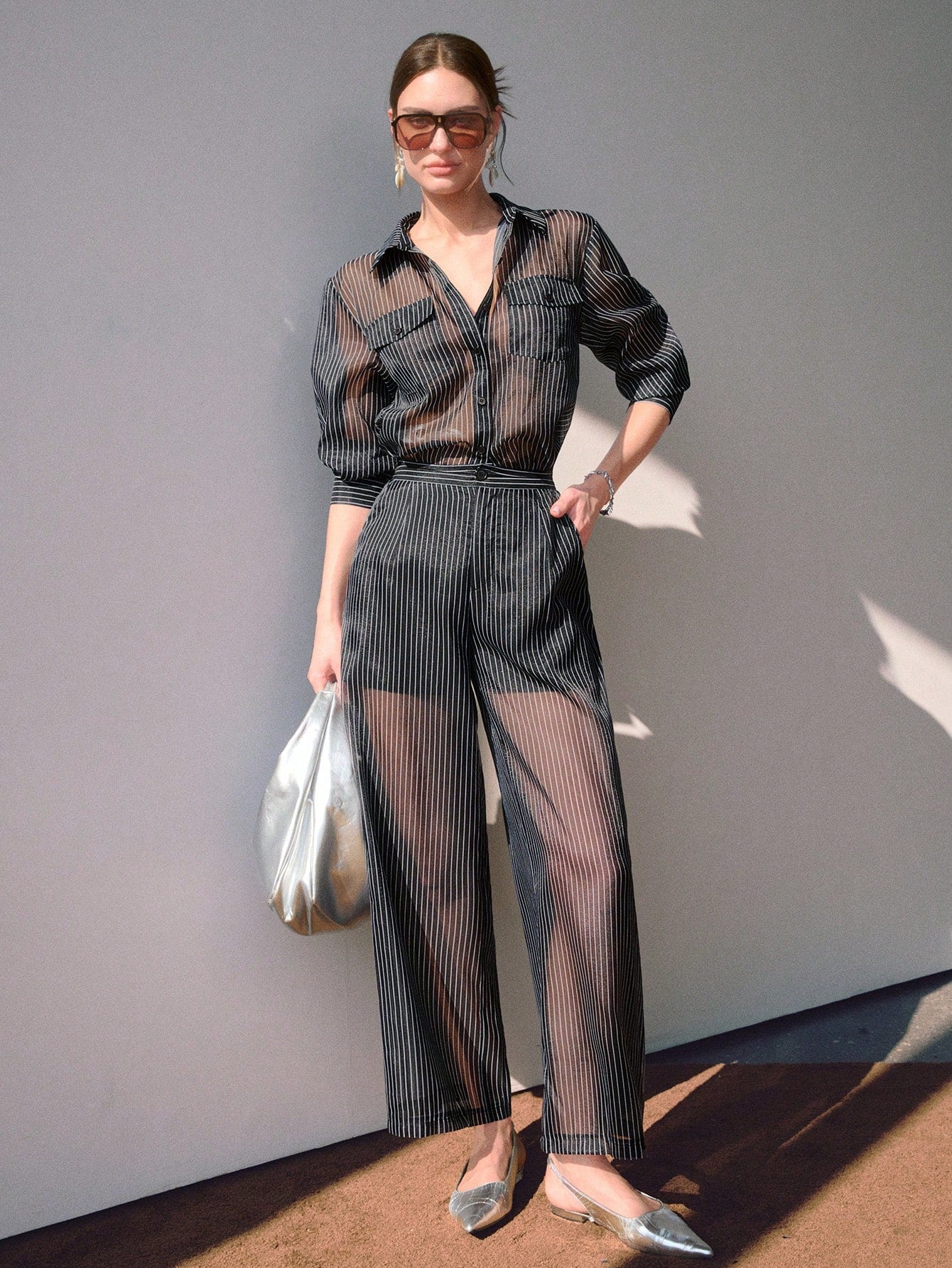 Woman wearing a sheer outfit with a plain background