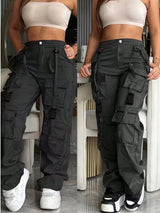 Person wearing black cargo pants with multiple pockets in two different poses.