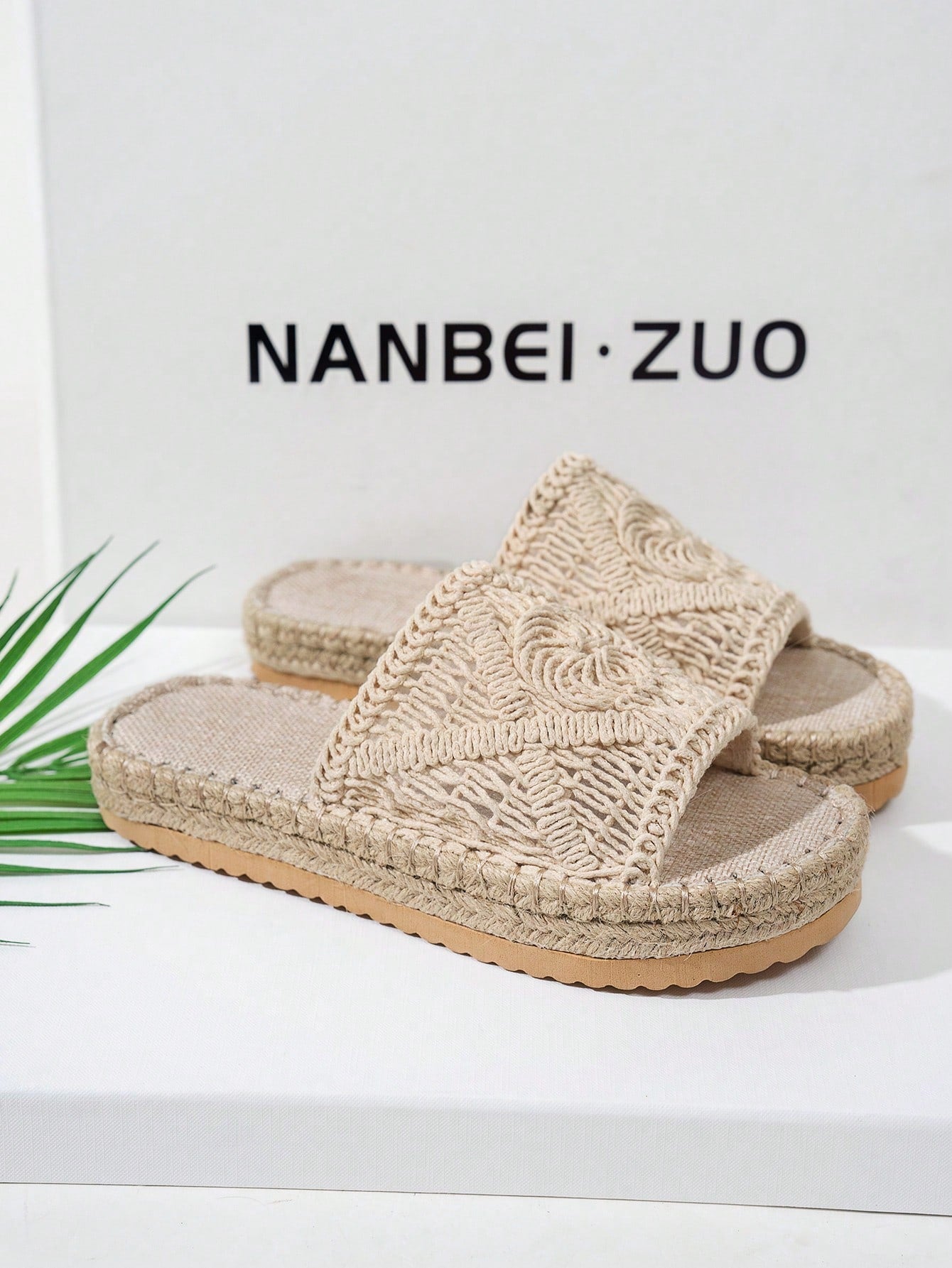 Beige espadrille sandals with woven design on a white background with 'NANBEI ZUO' branding.